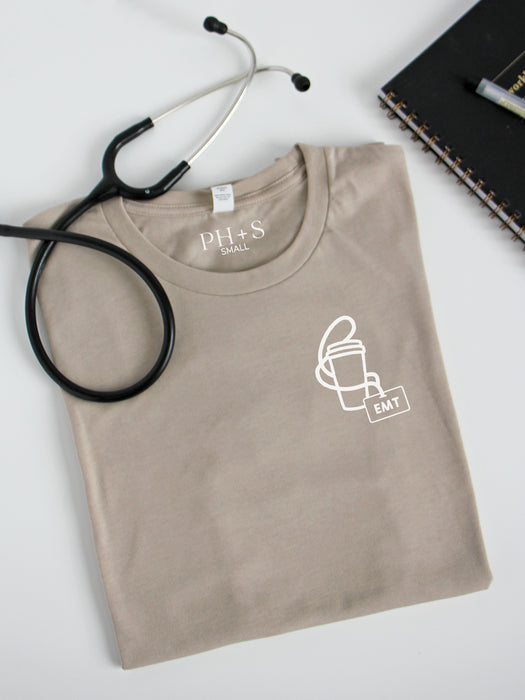 Cup + ID Badge on Heather Tan short sleeve tee